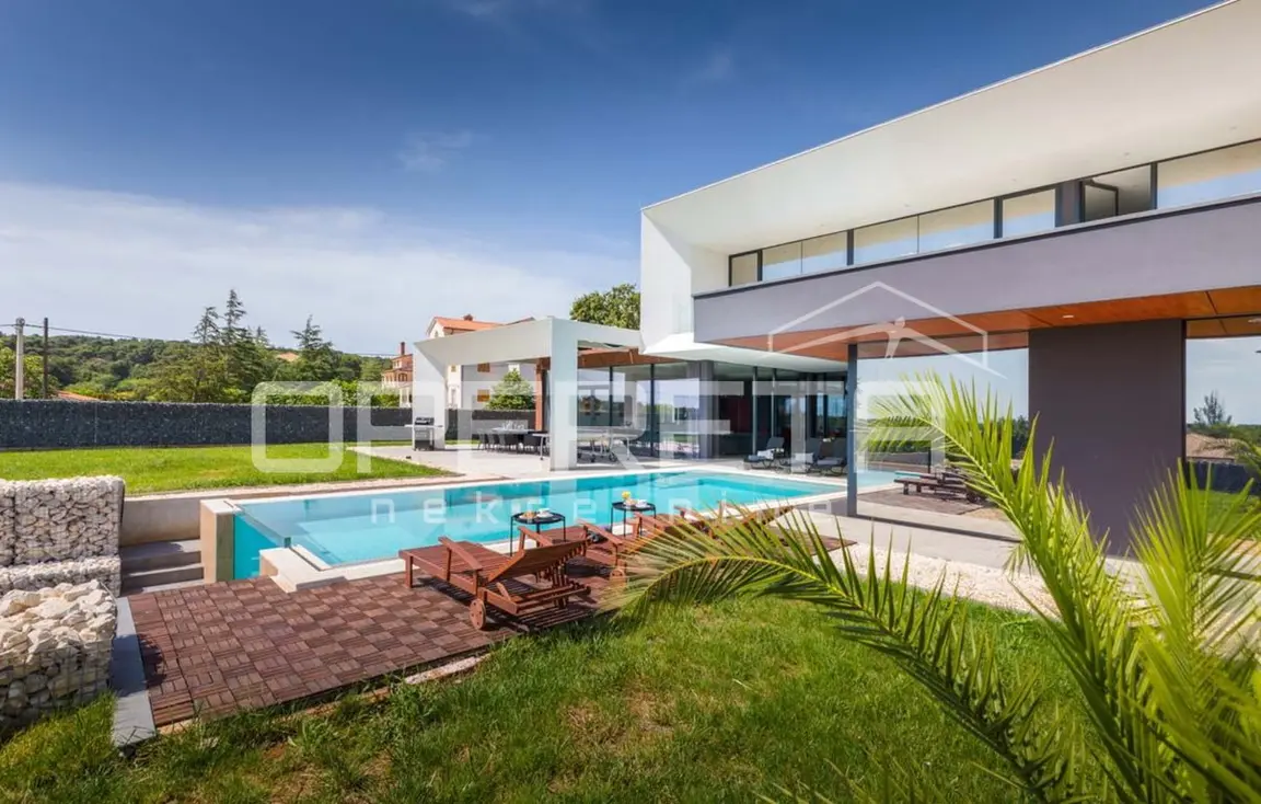 Garten mit Rasen, Palme und Pool vor der Villa